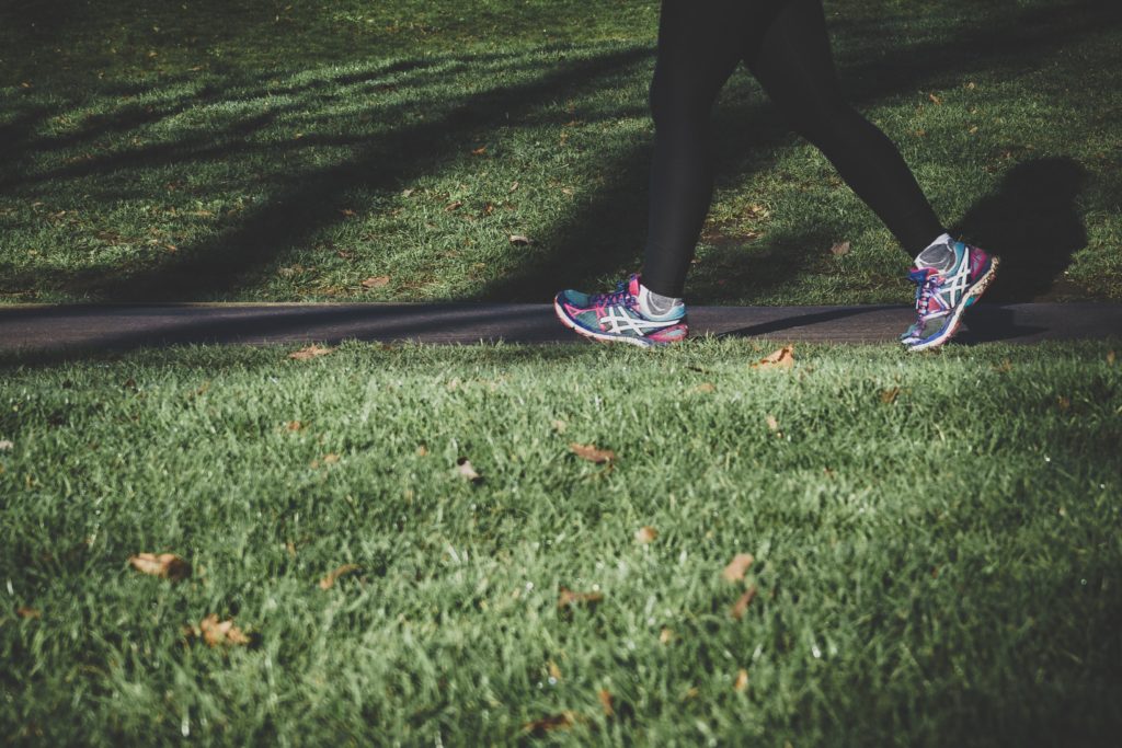 photo of legs walking on a grassy footpath