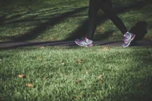 photo of legs walking on a grassy footpath