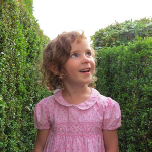 amazed young girl in garden labyrinth