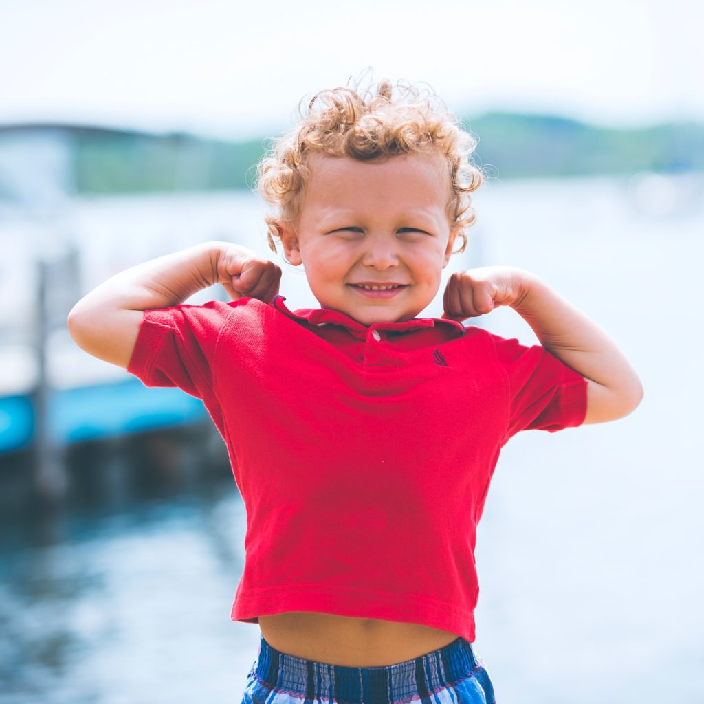 young curly-blonde boy stretching